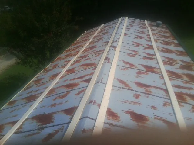 Rusted metal roof panels with new wood purlins before replacement — Storm Damage Roof Repair in Waymart by Roofing Brothers