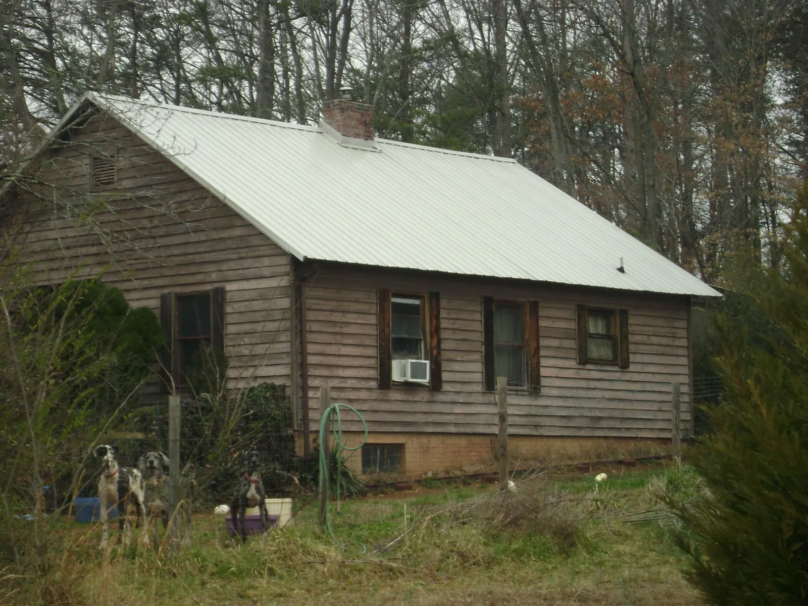 White metal roof on an old wood sided farmhouse, from a Metal Roof Installation job in Waymart